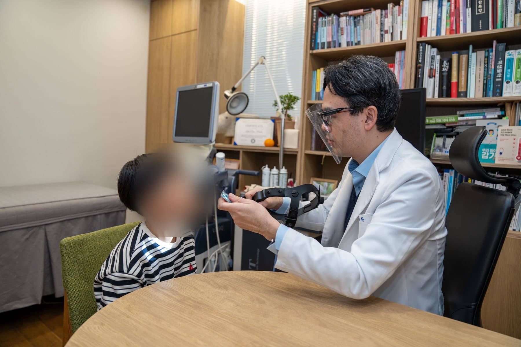 아이의 코 상태를 살피는 진료 모습